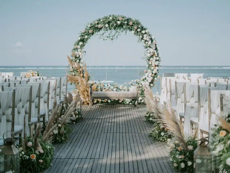 A floral arch framing the garden in daylight