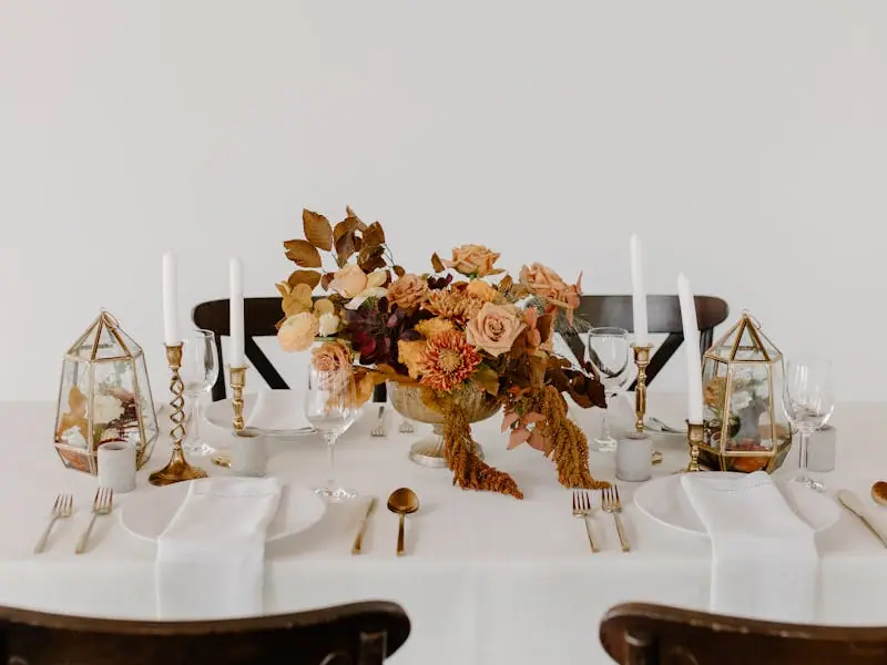 A long banquet table dressed with flowers and candles
