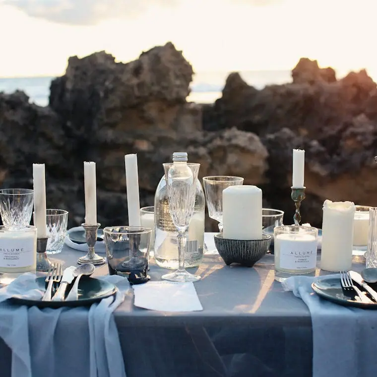 White pillar candles clustered on a reception table
